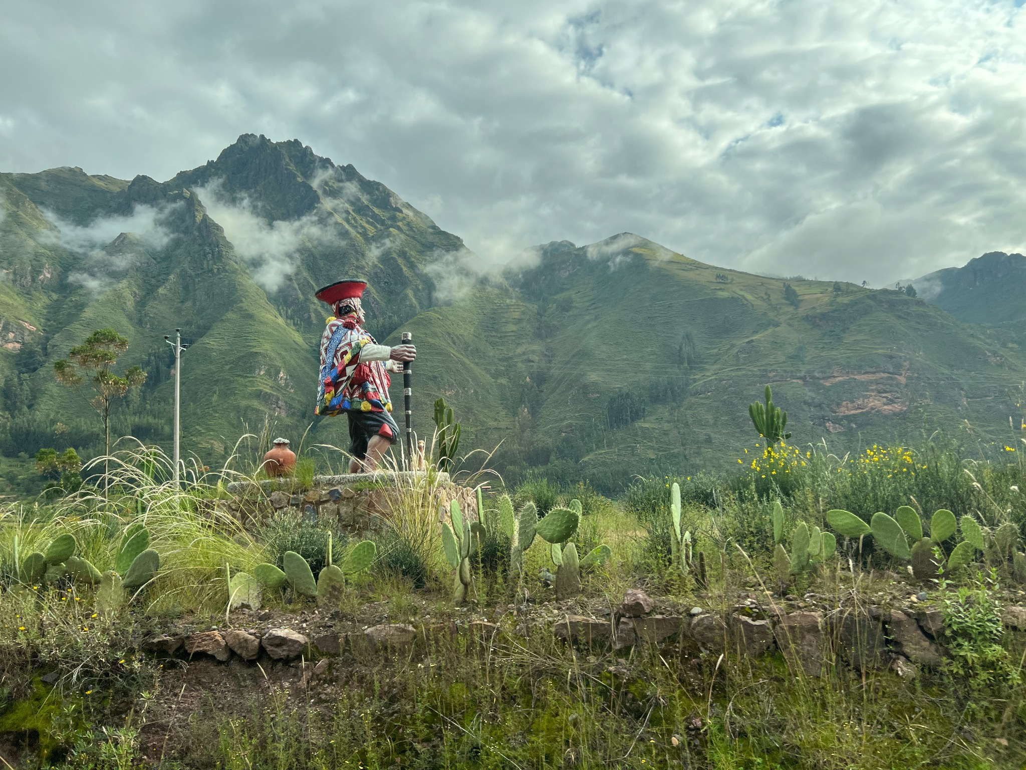 Andean mountain landscape with a traditional figure statue